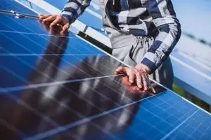 Person inspecting solar panels with explanation of their function